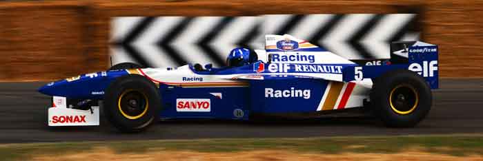 Blue and white racing car speeding on track, featured on digipdemo.com in an article about Damon Hill.
