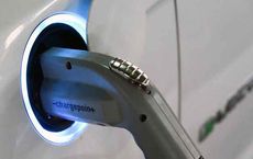 Electric car charger plugged into a vehicle, highlighting sustainable transportation on digipdemo.com.