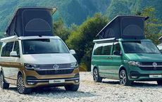 Two camper vans with pop-up roofs parked in a scenic mountain area, ideal for outdoor adventures.