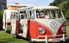 Vintage van modified as a camper parked outdoors on grass, showcasing creative vehicle repurposing on digipdemo.com.
