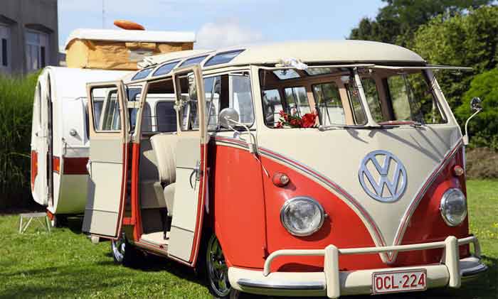 Vintage van modified as a camper parked outdoors on grass, showcasing creative vehicle repurposing on digipdemo.com.