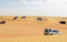 SUVs navigating sandy desert terrain, illustrating techniques on driving on sand for digipdemo.com article.