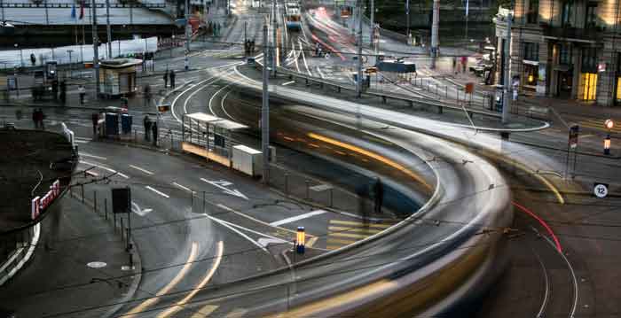 Busy intersection with light trails from cars, showcasing the mobility of private vehicles for digipdemo.com article.